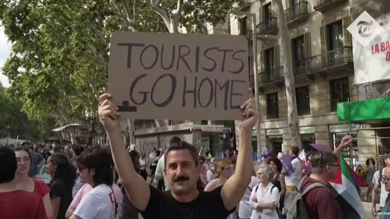 Moradores de Barcelona protestam contra o turismo de massa, um dos exemplos mais emblemáticos do fenômeno da turismofobia que afeta cidades históricas na Europa. - Foto: Reprodução/The New York Times