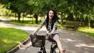 mulher andando de bicicleta feliz - Shutterstock
