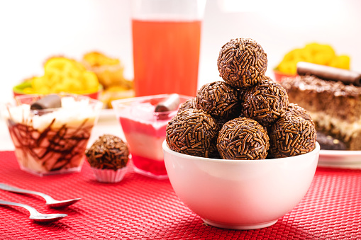 Brazilian chocolate bonbon, called Brigadeiro, made with condensed milk, chocolate powder and sprinkles, served with cake at birthday parties