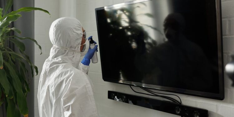 Pessoa limpando TV - Fonte: pexels